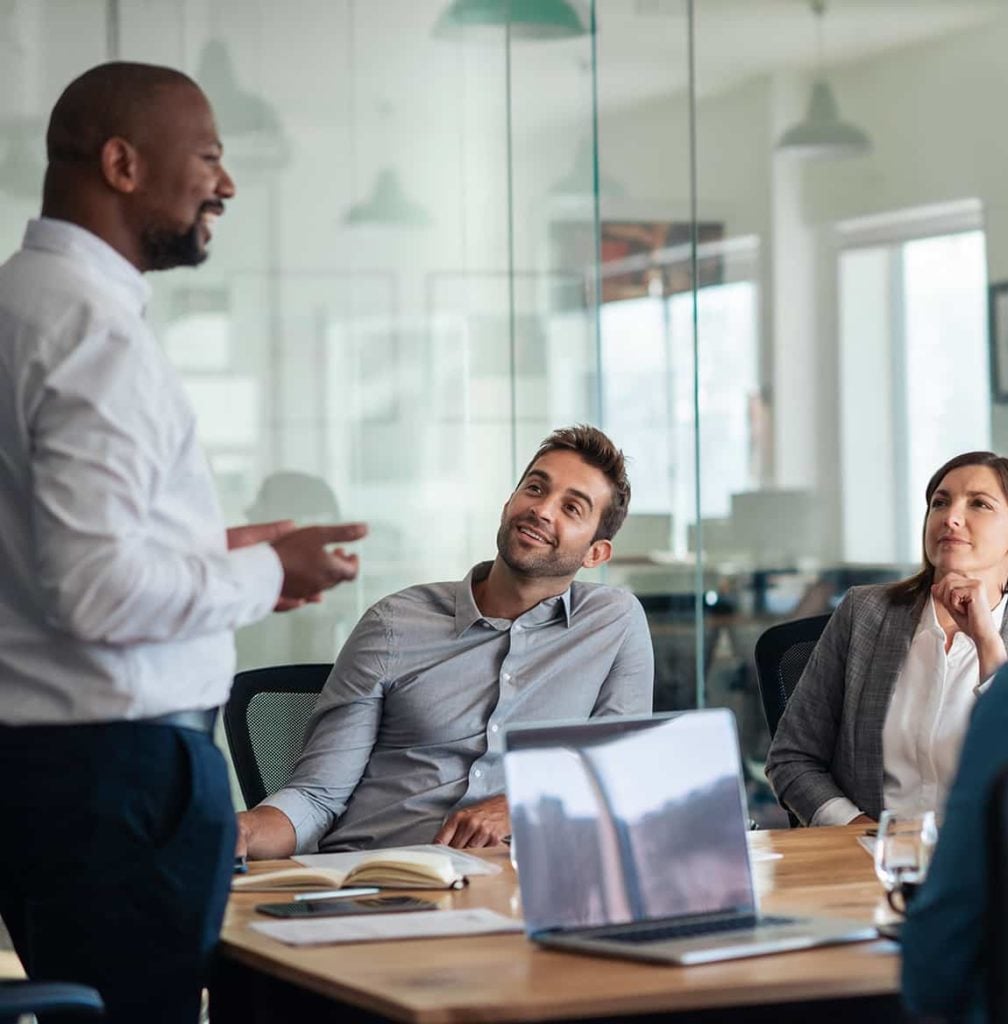 Business Team Meeting Around A Table with a Laptop