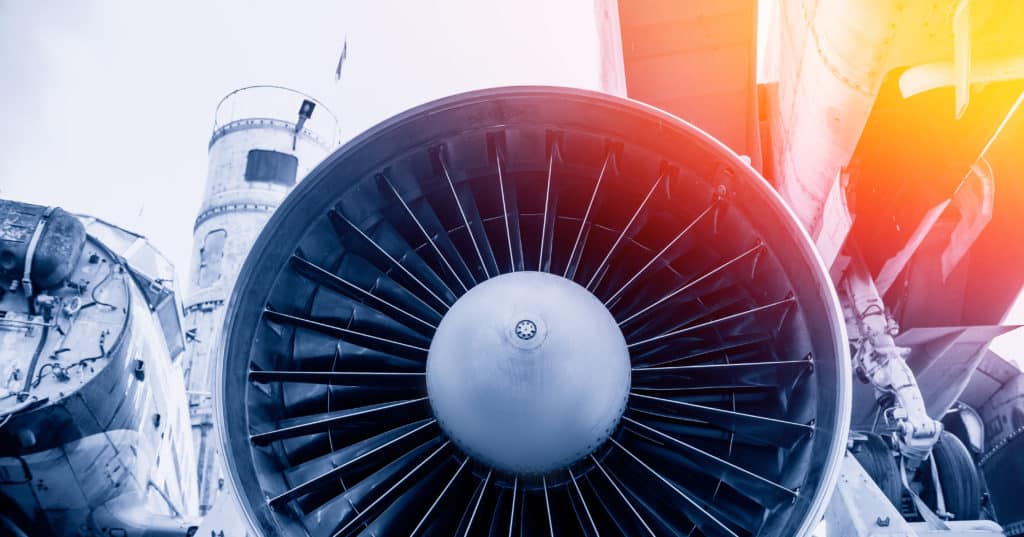 Closeup detail of turbine airplane engine blades. Blue color tone with sunlight.